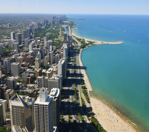 arial view of city with beach and deep blue ocean